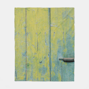 Closeup photo of yellow and teal wooden board fleece blanket