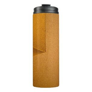 Closeup photo of yellow wall thermal tumbler
