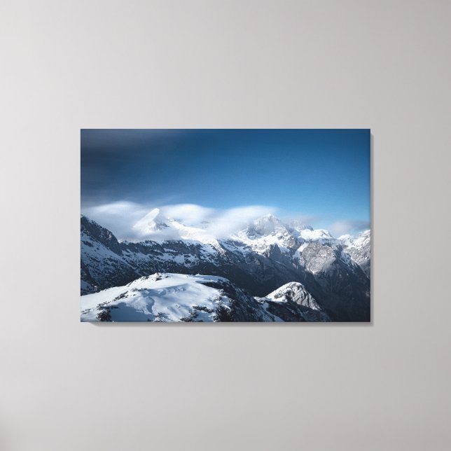 Clouds rolling above snowy mountains canvas print (Front)