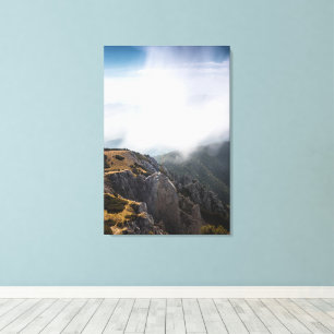 Clouds rolling over mountains canvas print