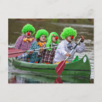 Clowns boating on river.