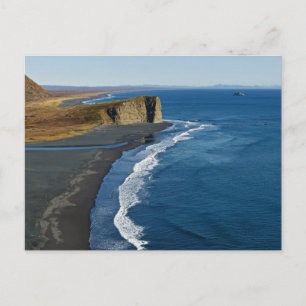 Coast of ocean with black volcanic sand on beach postcard