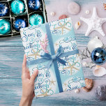 Coastal Beach Christmas SEAS & GREETINGS Wrapping Paper<br><div class="desc">Wrap your Christmas holiday gifts in coastal or beach flair using this roll of wrapping paper featuring a SEAS & GREETINGS elegant calligraphy script typography design accented with starfish in turquoise aqua blue on your choice of background colour (shown with a light blue colour). ASSISTANCE: For help with design modification...</div>