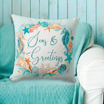 Coastal SEAS & GREETINGS Seahorse Shells Cushion<br><div class="desc">Coastal or beach themed Christmas holiday season throw pillow featuring watercolor seahorses, starfish, shells and ornaments accented with faux glitter icons and the greeting SEAS & GREETINGS in modern handwritten script typography in turquoise, teal, golden brown and white on your choice of background colour (shown in light turquoise). OPTIONS: The...</div>
