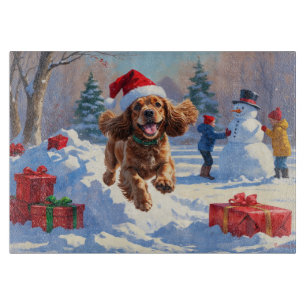 Cocker Spaniel Running in Snow with Christmas Hat Cutting Board