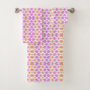 Colorful floral-patterned towels hang and lay flat