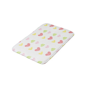 Colorful hearts on white bath mat