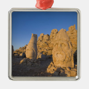 Colossal head statues of Gods guarding the 2 Metal Tree Decoration