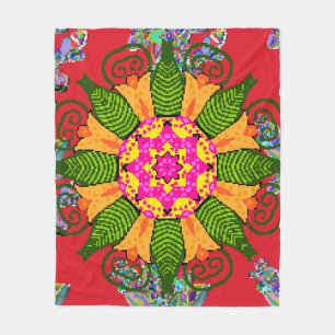 Coloured round floral mandala on a red, green and fleece blanket