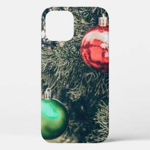 Colourful Christmas bauble decoration on a tree. V iPhone 12 Case