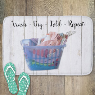 Colourful Folded Laundry On Hangers In Blue Basket Bath Mat