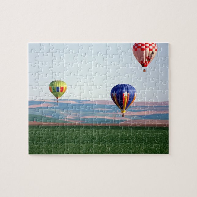 Colourful hot air balloons float over wheat jigsaw puzzle (Horizontal)