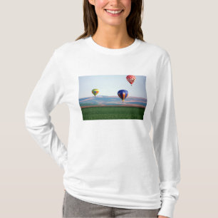 Colourful hot air balloons float over wheat T-Shirt