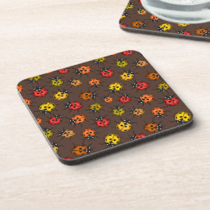 Colourful ladybugs on brown coaster