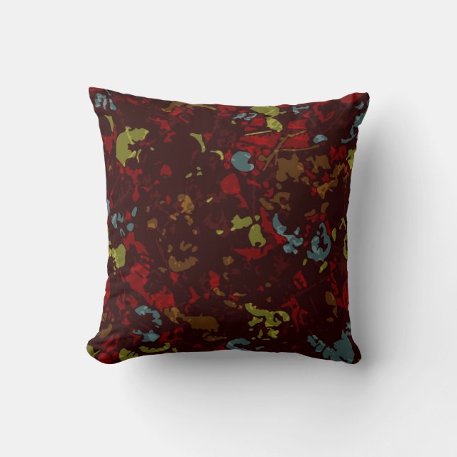 Colourful leaves and flowers against camouflage cushion (Front)