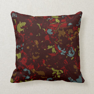 Colourful leaves and flowers against camouflage cushion