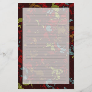 Colourful leaves and flowers against camouflage stationery