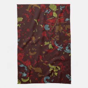Colourful leaves and flowers against camouflage tea towel