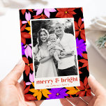 Colourful Merry and Bright Poinsettia Black Photo Holiday Card<br><div class="desc">Cute and colourful holiday photo card featuring a pattern of brightly coloured poinsettias in shades of red, orange, pink, and purple with a black background. "Merry and Bright" is displayed in trendy red-orange lettering. Personalise the front of the card by adding your vertical photo and name. The poinsettia holiday card...</div>