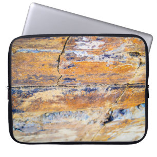 Colourful natural stone wall pattern in a quarryan laptop sleeve