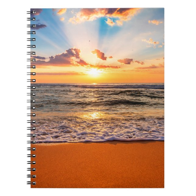 Colourful ocean beach sunrise with deep blue sky a notebook (Front)