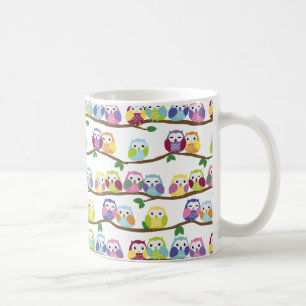 Colourful owls on a branch coffee mug