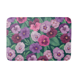 Colourful pansies on dark greenish blue bath mat