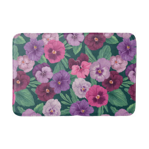Colourful pansies on dark greenish blue bath mat