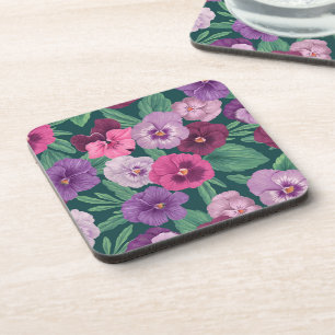 Colourful pansies on dark greenish blue coaster