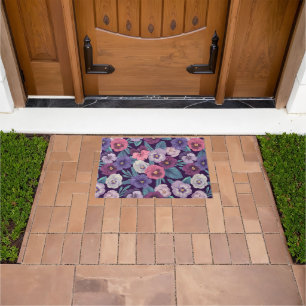 Colourful pansies on deep violet doormat