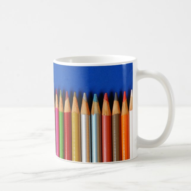 Colourful pencil crayons on blue background coffee mug (Right)