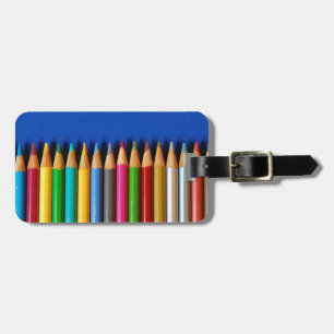 Colourful pencil crayons on blue background luggage tag