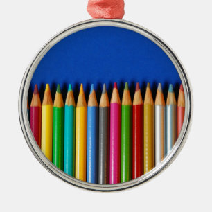 Colourful pencil crayons on blue background metal tree decoration