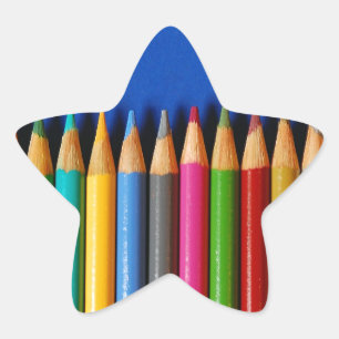 Colourful pencil crayons on blue background star sticker