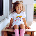 Colourful Rainbow Sunshine Birthday Kids T-Shirt<br><div class="desc">Celebrate her special day with this vibrant white tee featuring an illustrated rainbow with clouds and sunshine above bold multicolor "Birthday" lettering. The name, age number, and birthday details are all easy to customise for a personalised party-day look. Perfect for rainbow-themed birthdays, party photos, and making the guest of honour...</div>
