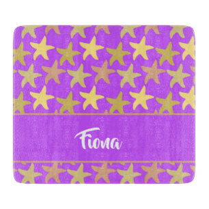 Colourful starfish on purple cutting board
