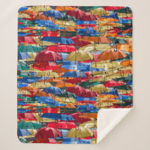 Colourful umbrellas in the sky blue orange red sherpa blanket