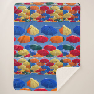 Colourful umbrellas in the sky blue orange red sherpa blanket