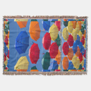 Colourful umbrellas in the sky blue orange red throw blanket