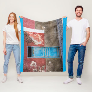 Colourful wall with blue door fleece blanket