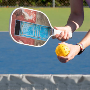 Colourful wall with blue door pickleball paddle