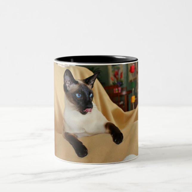 Comical Seal Point Siamese Cat Licking It's Nose Two-Tone Coffee Mug (Center)