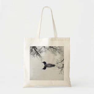 Common Loon Swims in a Northern Lake in Winter Tote Bag