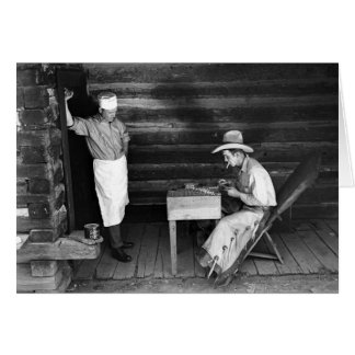 Cook watching a cowboy play cards