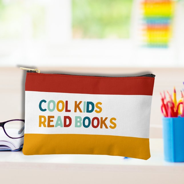 Cool kids read books, retro pencil case accessory pouch (Retro multi colored pencil case  on a child's study desk with the text Cool kids read books)