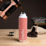 Coral Personalised Wedding Bridesmaid Water Bottle<br><div class="desc">Gift your wedding bridesmaid or maid of honour with this trendy, vacuum Insulated water bottle that features her name in white, stylised script on a coral colour background designed to match your wedding colour scheme . Personalise bottle by editing and replacing name with your own as desired. Select your water...</div>