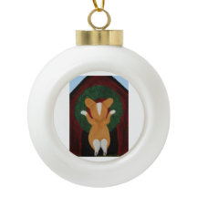 Corgi putting Christmas Wreath on Doghouse