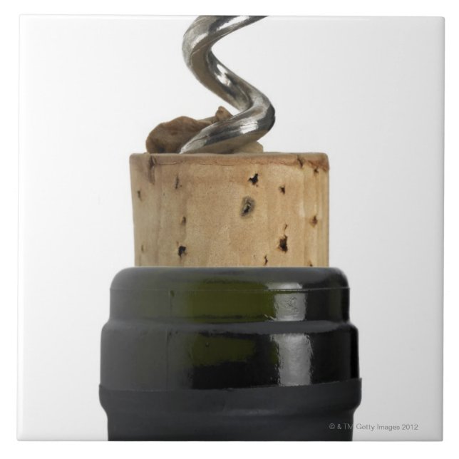 Corkscrew and cork, photographed on white tile (Front)