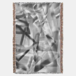 Corner of square pieces of acrylic, grey to white throw blanket