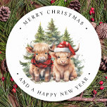 Cosy Highland Cow Farm Animals Merry Christmas  Classic Round Sticker<br><div class="desc">Looking for the cutest Christmas cards of the season! Our Highland Cow duo featuring two holiday calves are sure to bring a smile to your loved ones' faces. The design is adorable with the calves wearing a Santa hat and a plaid winter scarf, surrounded by trees and a cosy winter...</div>